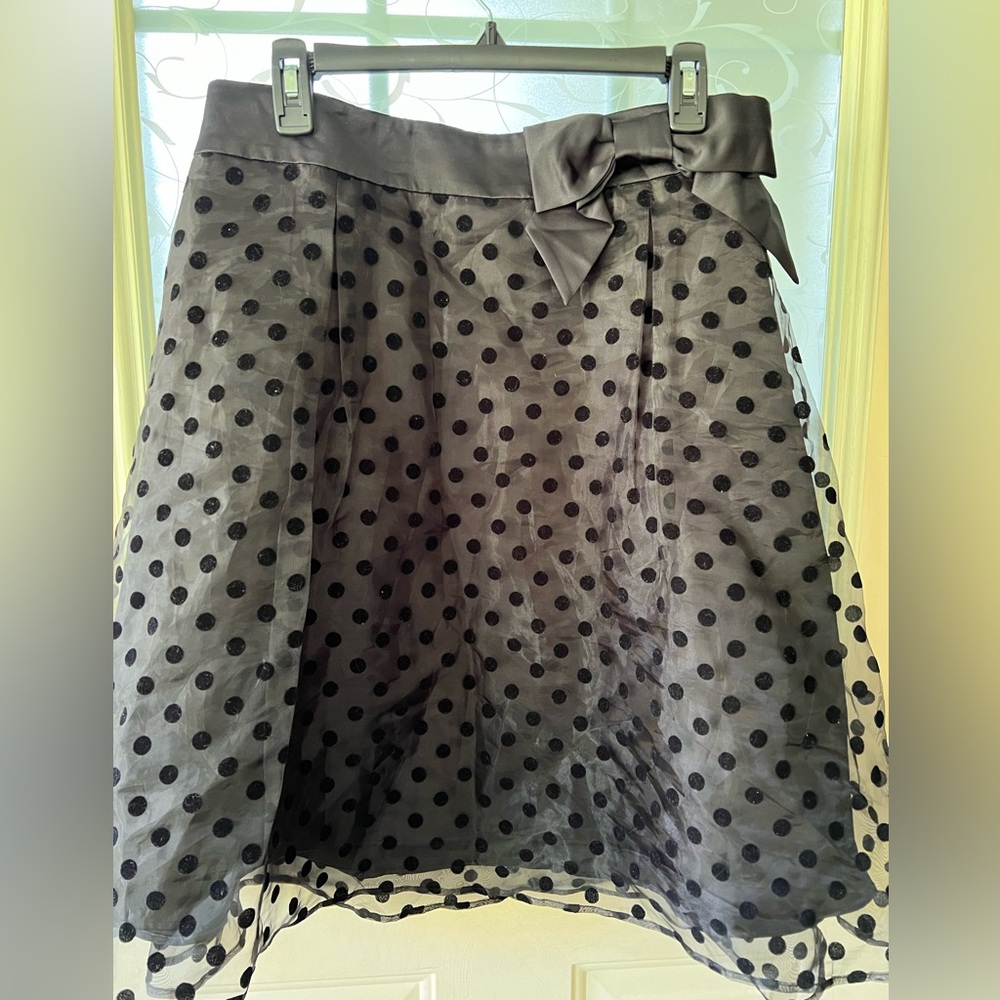 Elle size 14 polka dot organza over black satin. Waist is also satin and bow.
